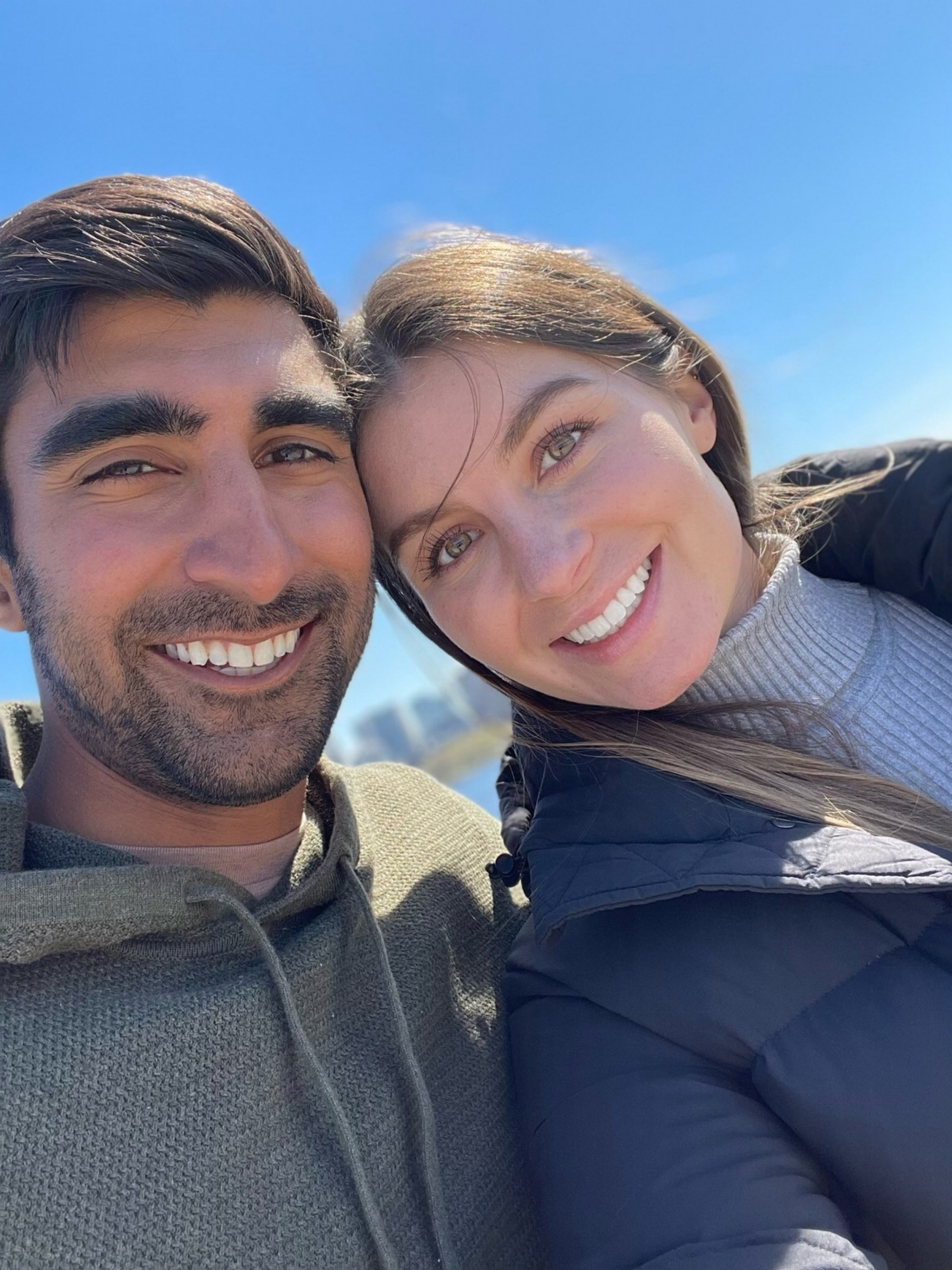 Cate and Brij smiling together outdoors