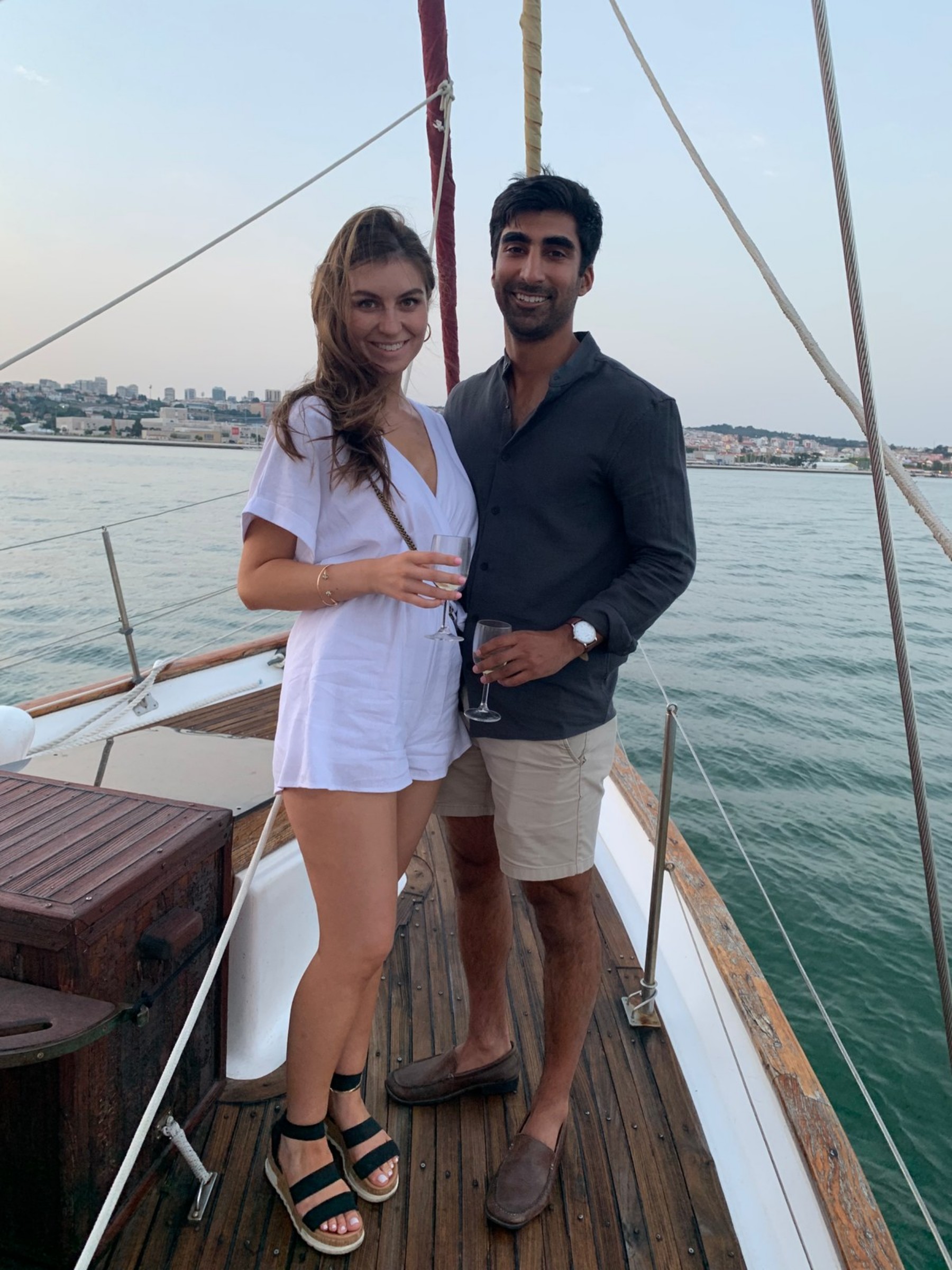 Cate and Brij together on a sailboat in Portugal