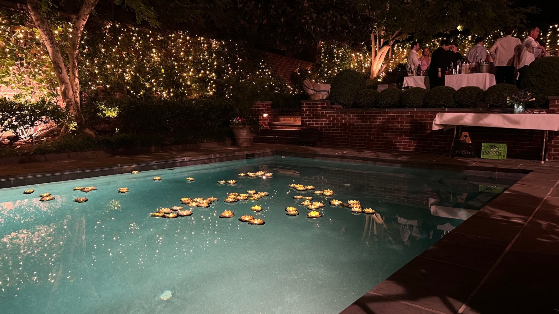 Floating candles and twinkling lights around the pool at the DC engagement party
